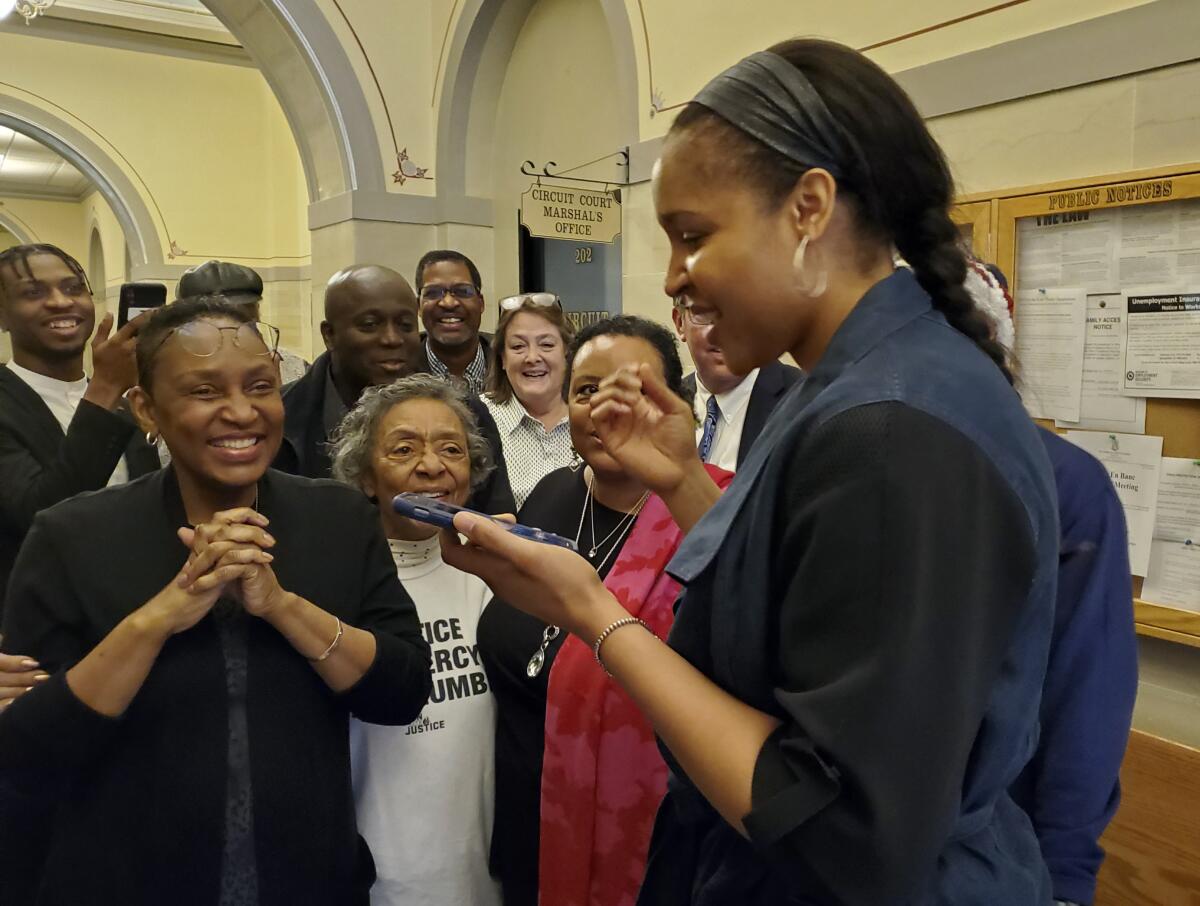 FILE - In this March 9, 2020, file photo, Jefferson City, Mo., native Maya Moore, right, calls Jonathan Irons as supporters react in Jefferson City, Mo., after Cole County Judge Dan Green overturned Irons' convictions in a 1997 burglary and assault case. Moore left the WNBA in 2019 to help her now husband Jonathan Irons get his conviction overturned and win his release from prison. Moore, 32, remains non-committal to returning to the WNBA. A documentary of their story — “Breakaway” — that was produced by Robin Roberts will air next week on ESPN. (Jeff Haldiman/The Jefferson City News-Tribune via AP, File)