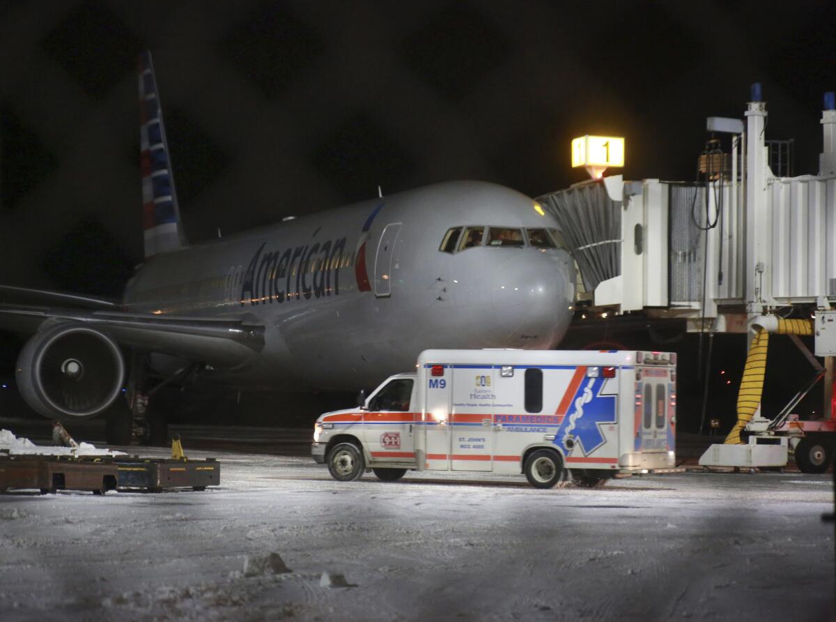 An ambulance leaves St. John's International Airport on Sunday in St. John's, Newfoundland. Several people were taken to a hospital after an American Airlines plane from Miami to Milan made an emergency landing after the jet briefly encountered severe turbulence.