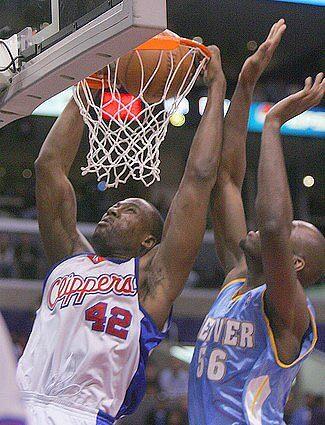 Clipper Elton Brand, left, slam dunks in front of Denver Nugget center Francisco Elson.