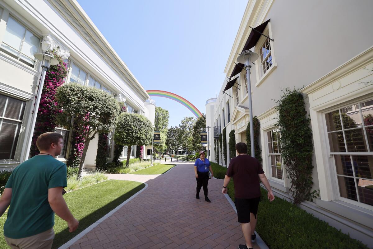 A Culver City movie studio with a rainbow sculpture in the distance.