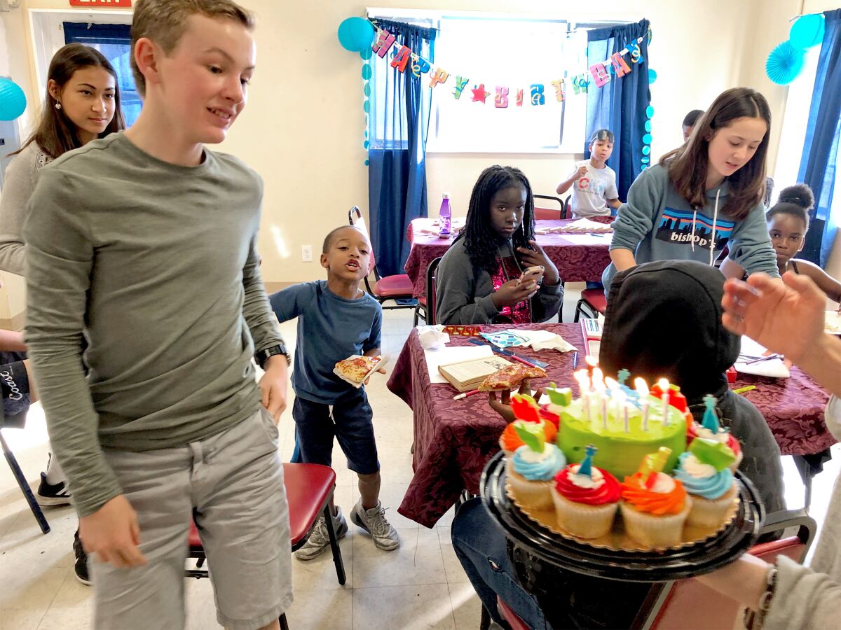 Daxton Gutekunst, founder of Kid By Kid volunteer tutoring organization celebratating students' birthdays.