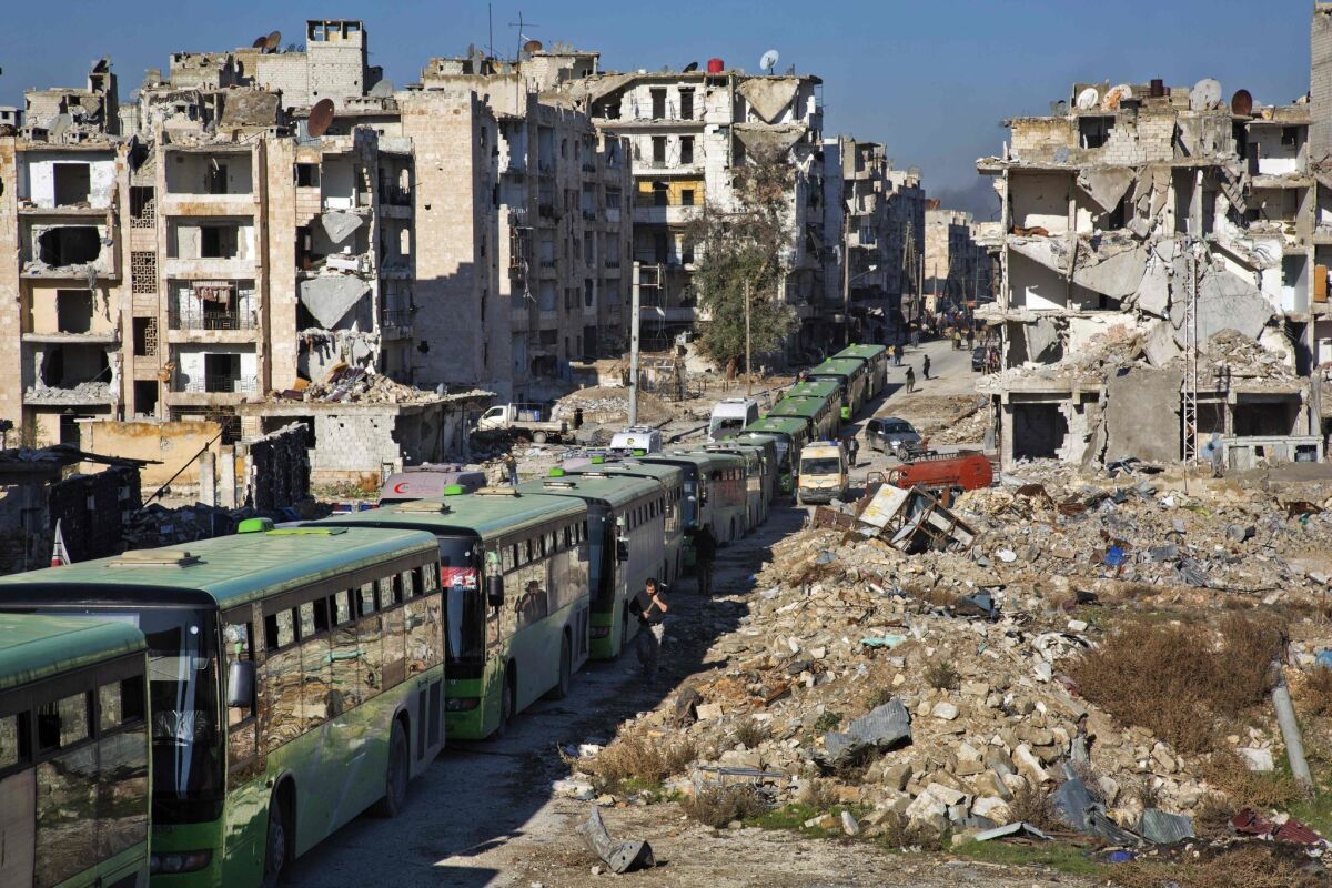 EDITORS NOTE: Graphic content / Buses are seen during an evacuation operation of rebel fighters and their families from rebel-held neighbourhoods in the embattled city of Aleppo on December 15, 2016. A convoy of ambulances and buses left rebel territory in Aleppo in the first evacuations under a deal for opposition fighters to leave the city after years of fighting. The rebel withdrawal will pave the way for President Bashar al-Assad's forces to reclaim complete control of Syria's second city, handing the regime its biggest victory in more than five years of civil war. / AFP PHOTO / KARAM AL-MASRIKARAM AL-MASRI/AFP/Getty Images ** OUTS - ELSENT, FPG, CM - OUTS * NM, PH, VA if sourced by CT, LA or MoD **
