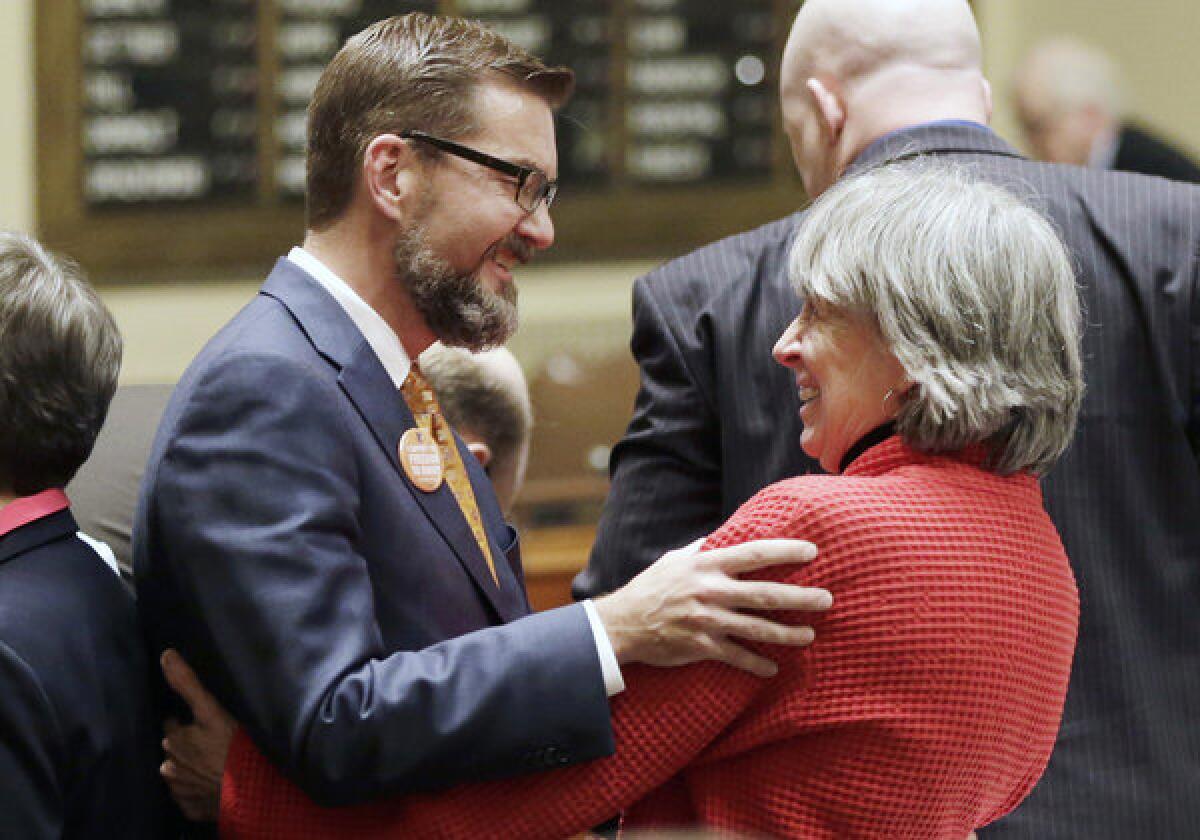 Last week, gay marriage sponsors Rep. Karen Clark, right, and Sen. Scott Dibble celebrate after the Minnesota House passed the gay marriage bill. The two openly gay Minnesota state lawmakers, who respectively sponsored the measure in the state House and Senate, prepared to watch Democratic Gov. Mark Dayton sign the bill in a ceremony Tuesday.