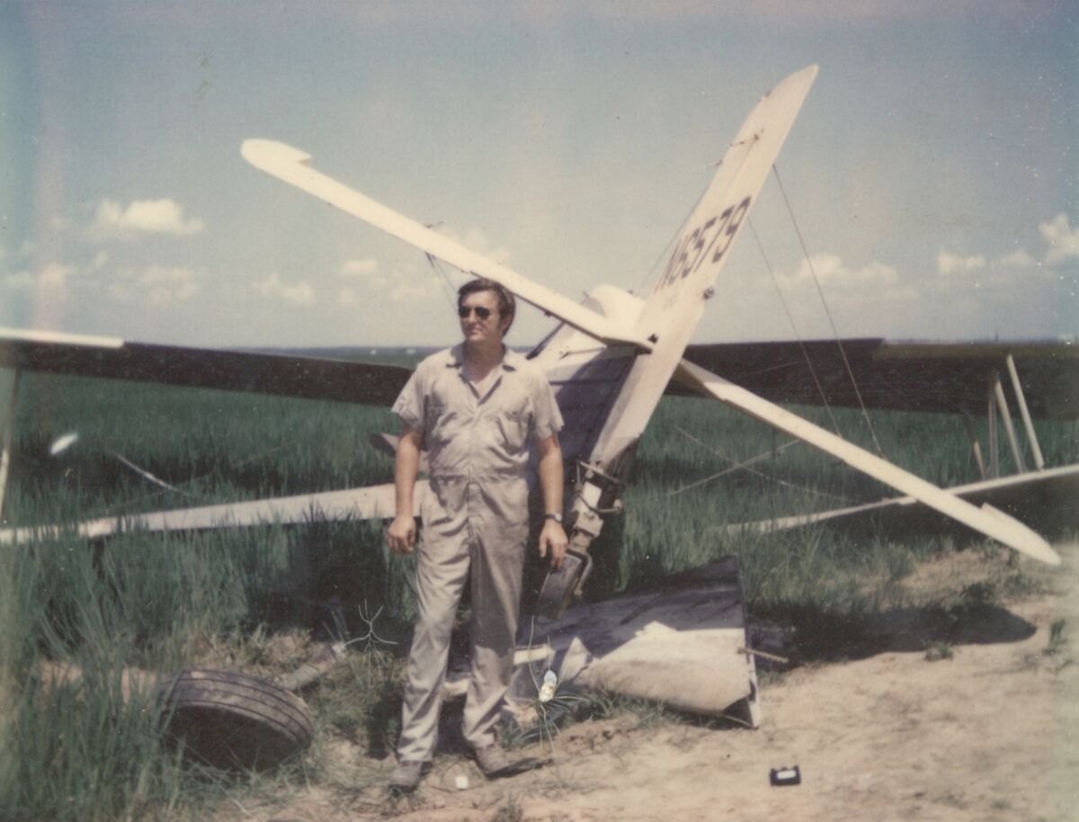 Pilot Gary Betzner with one of his crashed planes. 