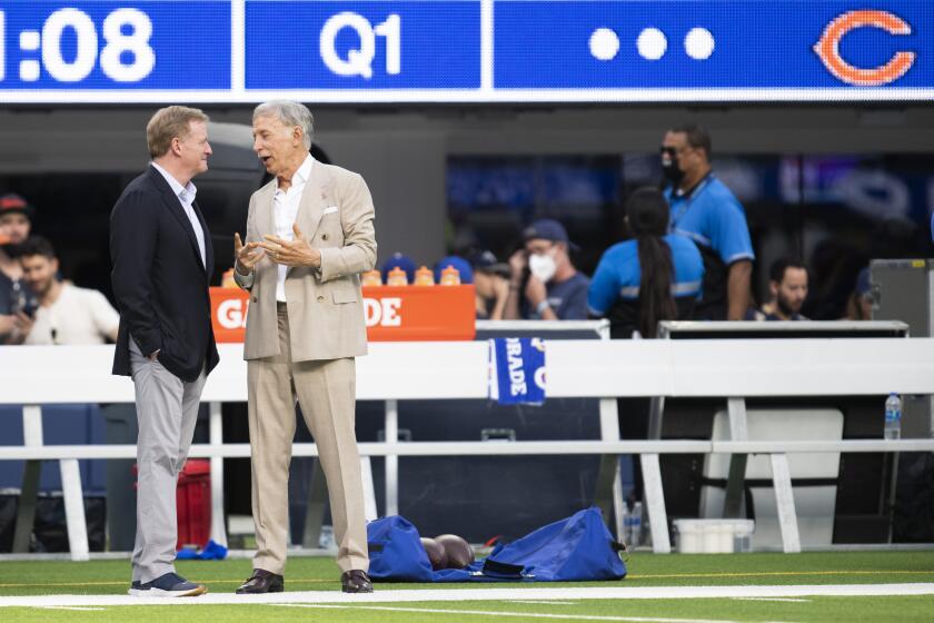 Rams owner Stan Kroenke and NFL commissioner Roger Goodell chat before a game between the Bears and the Rams 