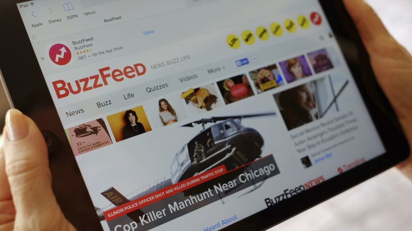The BuzzFeed website is displayed on an iPad in 2015.