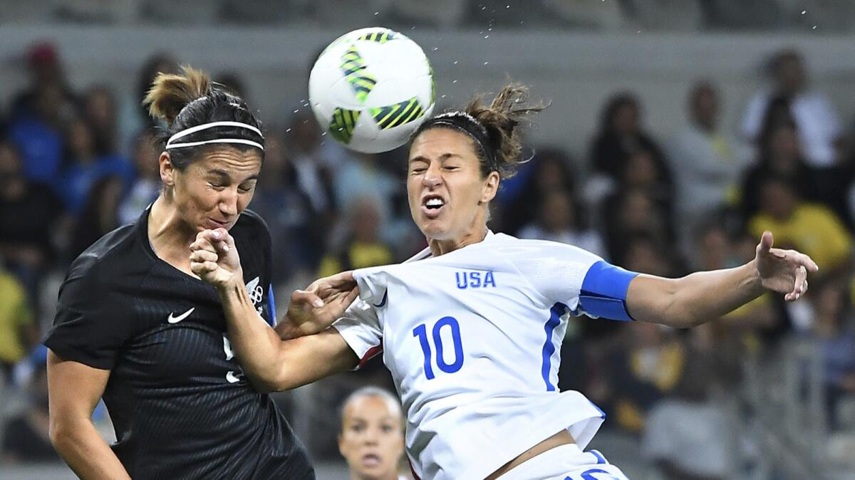 USA's Carli Lloyd (10) and New Zealand's Abby Erceg battle for the ball in the first half in Belo Horizonte, Brazil, at the Rio Olympics on Wednesday.
