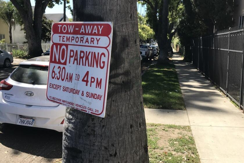 The Los Angeles Bureau of Street Services posts temporary no-parking signs on streets when repairs are done. The placards, attached to trees and signposts with wire, are typically turned away from the street during periods when work is not occurring.