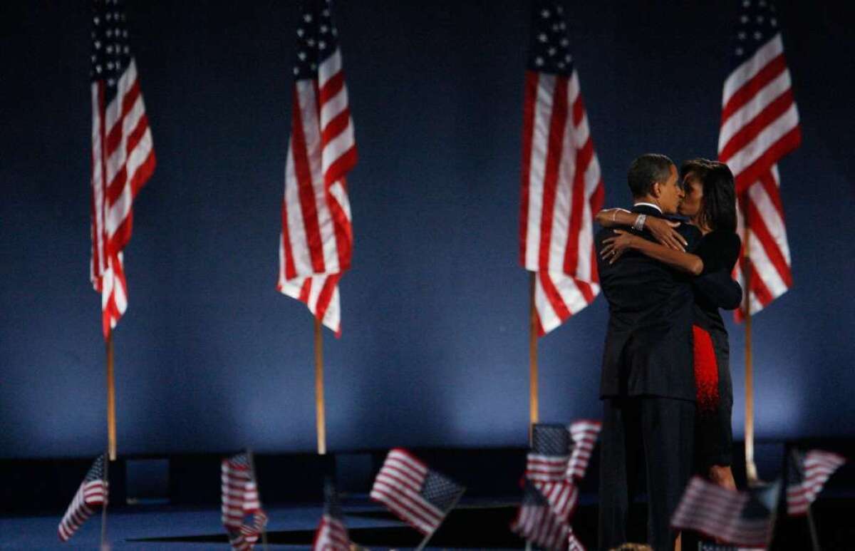 U.S. President-elect Barack Obama kisses his wife, Michelle, after Obama gave his victory speech during an election night gathering in Grant Park on Nov. 4, 2008 in Chicago.