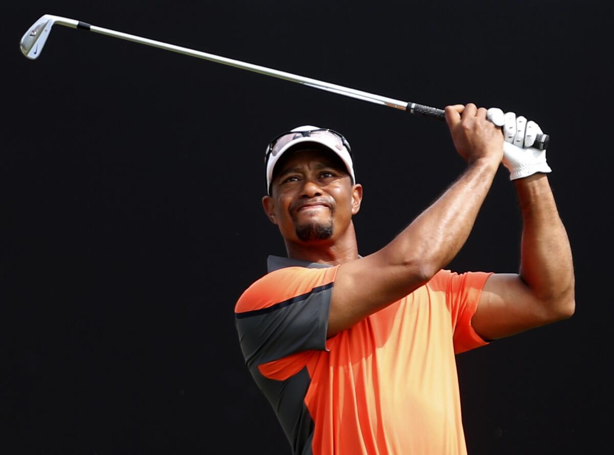 Tiger Woods, shown back in February, is reportedly on the road to recovery after March back surgery.
