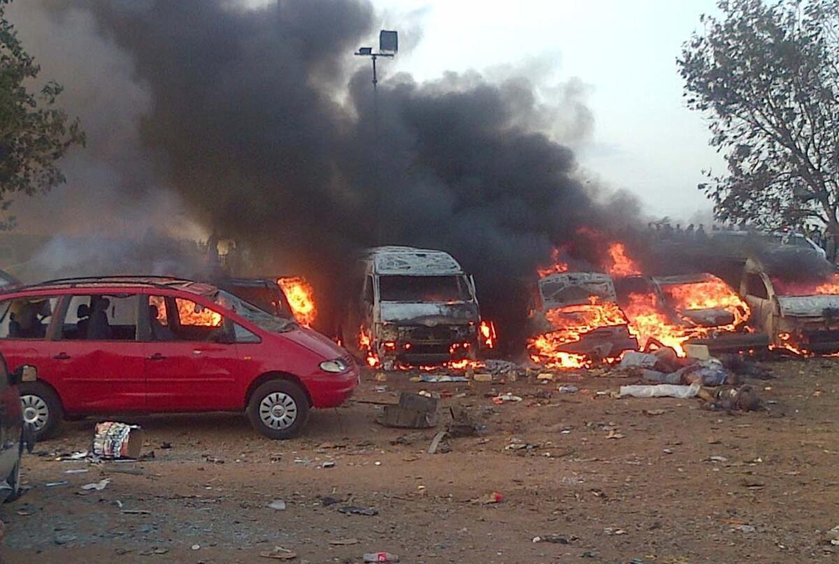 Vehicles burn after a bombing at a bus station in the Nigerian city of Abuja.