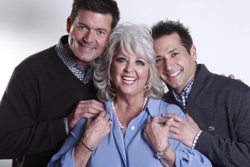 Paula Deen's two sons, Jamie, left, and Bobby, defended their mother against accusations of racism, saying they were raised in a loving home where bigotry did not exist.