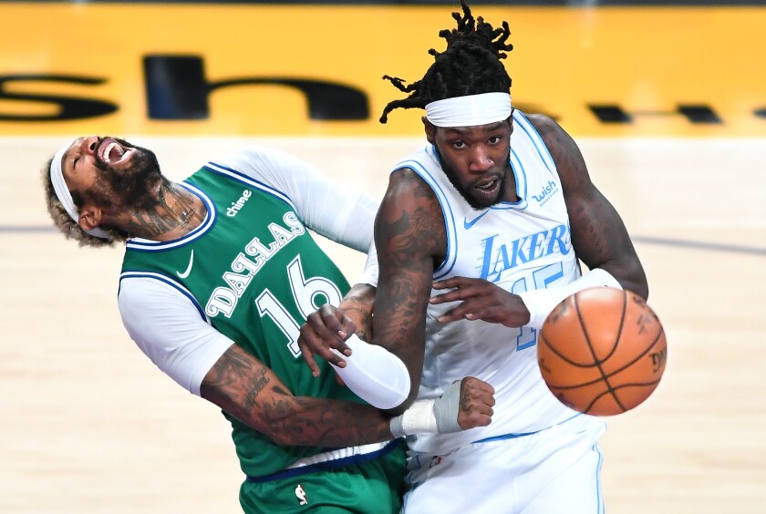 Lakers forward Montrezl Harrell collides with Dallas Mavericks forward James Johnson.