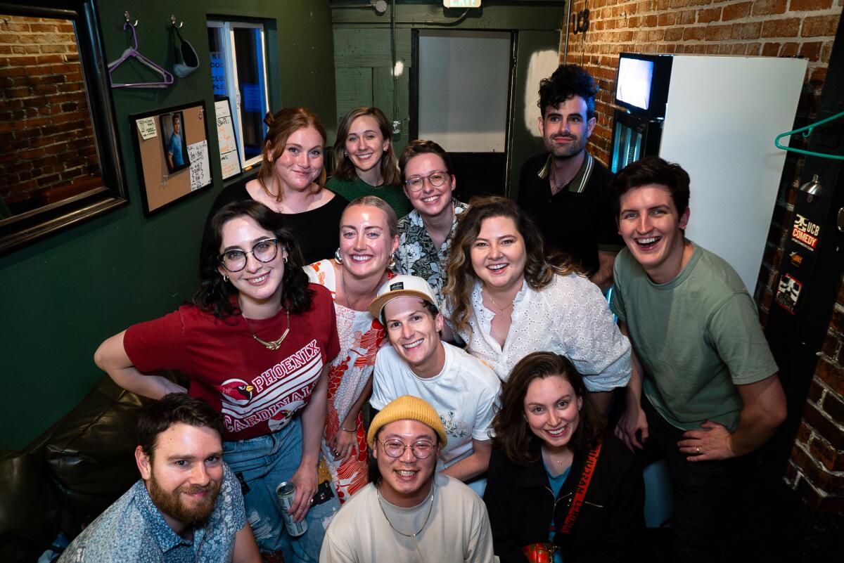 A group of young adults posing for a photo in an office.