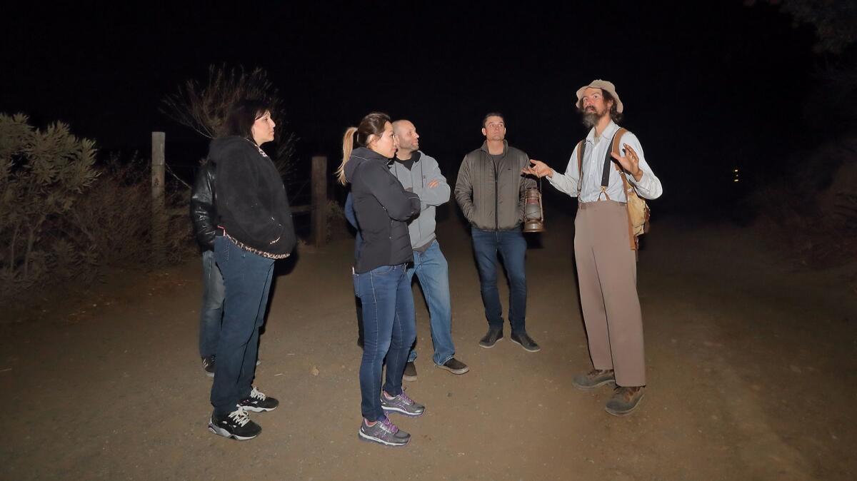 Guide Joel Robinson, far right, leads a tour of Black Star Canyon in Silverado as part of Haunted OC on Oct. 13.