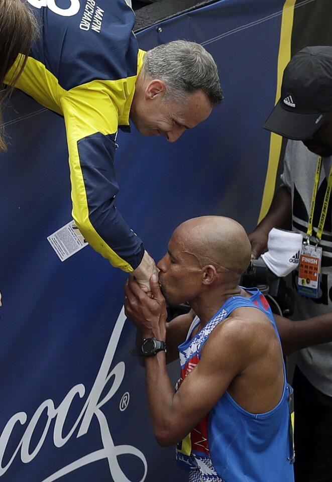 Meb Keflezighi, a Boston Marathon winner, throws out the ceremonial first  pitch before a baseball game between the Boston Red Sox and the Los Angeles  Angels, Friday, April 14, 2023, in Boston. (