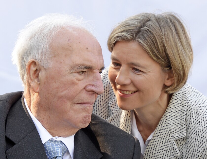 FILE - Former German Chancellor Helmut Kohl, left, talks with his wife Maike Kohl-Richter after unveiling of a memorial stone to honour Kohl's work for the German reunification in Moedlareuth, Germany, May 21, 2013. A German federal court ruled on Monday that the widow of former Chancellor Angela Kohl isn't entitled to 1 million euros, 1.1 million Dollars, in damages that the country's late leader was awarded in a legal battle with his one-time ghostwriter. Kohl was awarded the damages shortly before he died in 2017 by a Cologne court, which found that the ghostwriter had violated his privacy rights. (AP Photo/Jens Meyer, File)