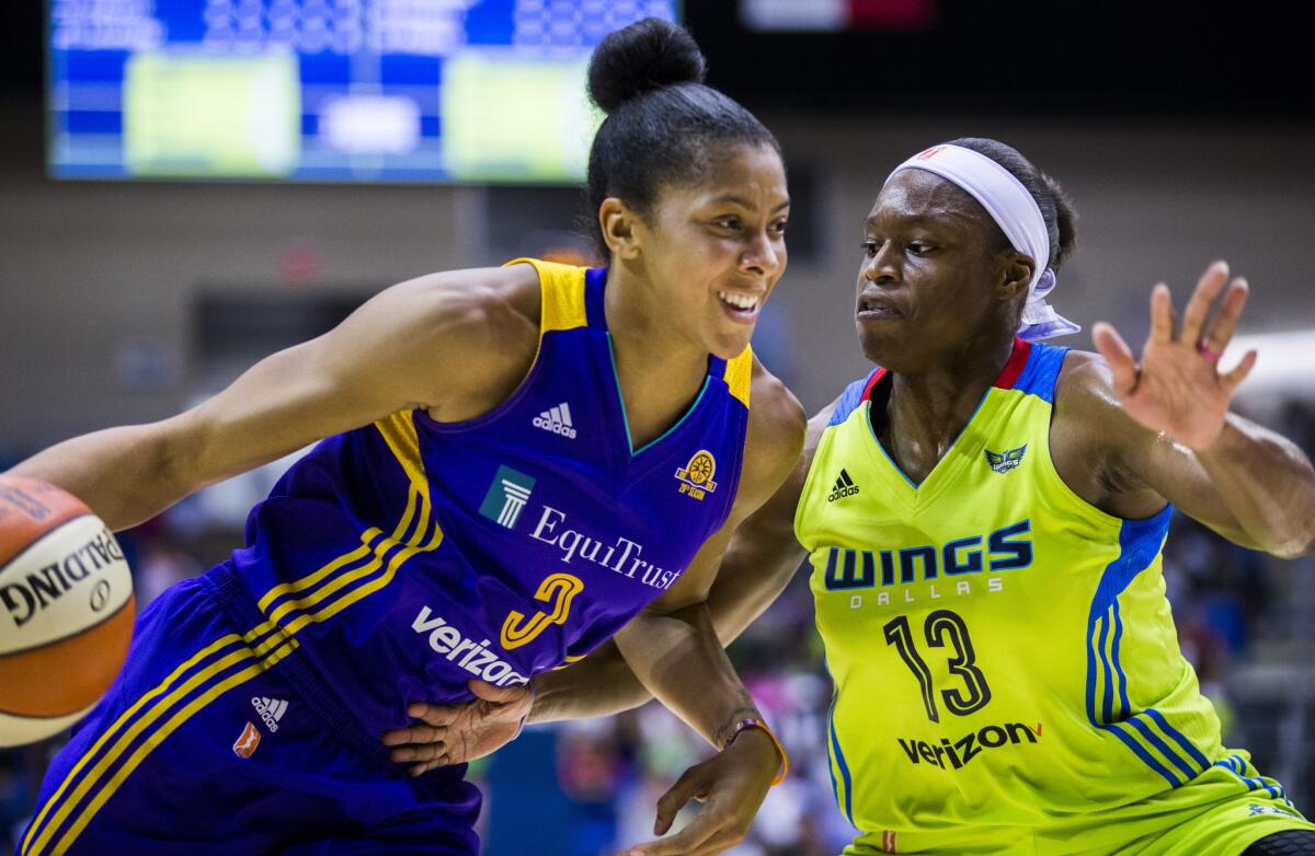 Candace Parker, driving against Karima Christmas of the Dallas Wings, has helped the Sparks set a franchise record with 10 consecutive season-opening victories.