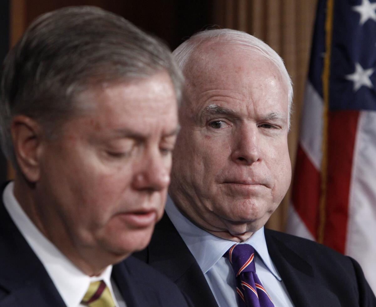 Sen. John McCain (R-Ariz.), right, listens as Sen. Lindsey Graham (R-S.C.) discusses the investigation of the deadly Sept. 11 attack on the U.S. consulate in Benghazi during a news conference on Capitol Hill.