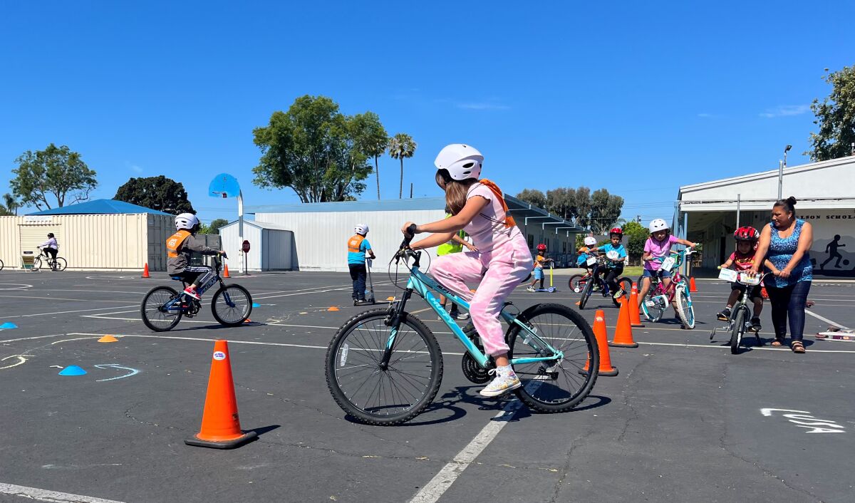 Kids learn bike safety on a Walk n' Rollers skills course at Wilson Elementary in May 2022.