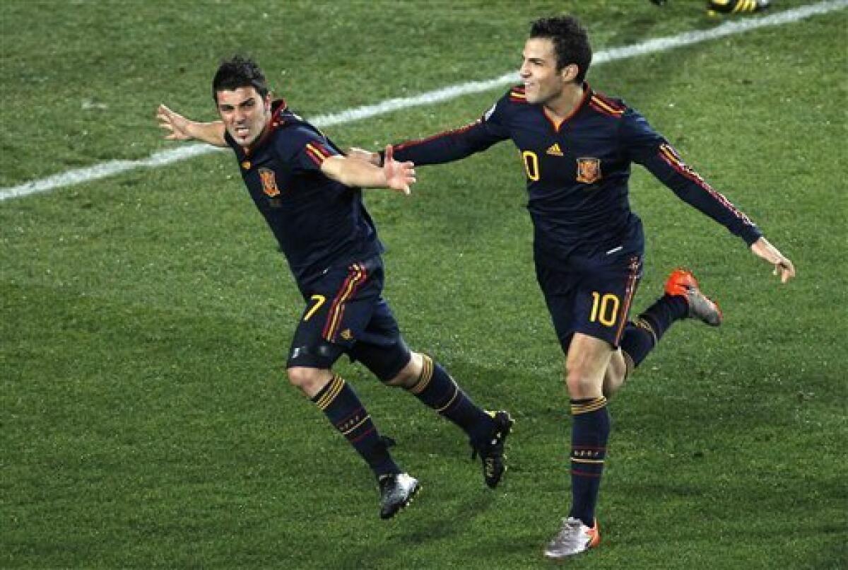 Spain's David Villa, left, celebrates with teammate Cesc Fabregas after scoring a goal during the World Cup quarterfinal soccer match between Paraguay and Spain at Ellis Park Stadium in Johannesburg, South Africa, Saturday, July 3, 2010. (AP Photo/Hassan Ammar)