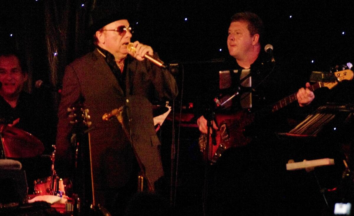 Irish musician Van Morrison, center, performs at the Slieve Donard Resort and Spa in Newcastle, Northern Ireland, near his hometown of Belfast, with his band that also included drummer Robbie Ruggiero, left, and bassist Paul Moore, right.