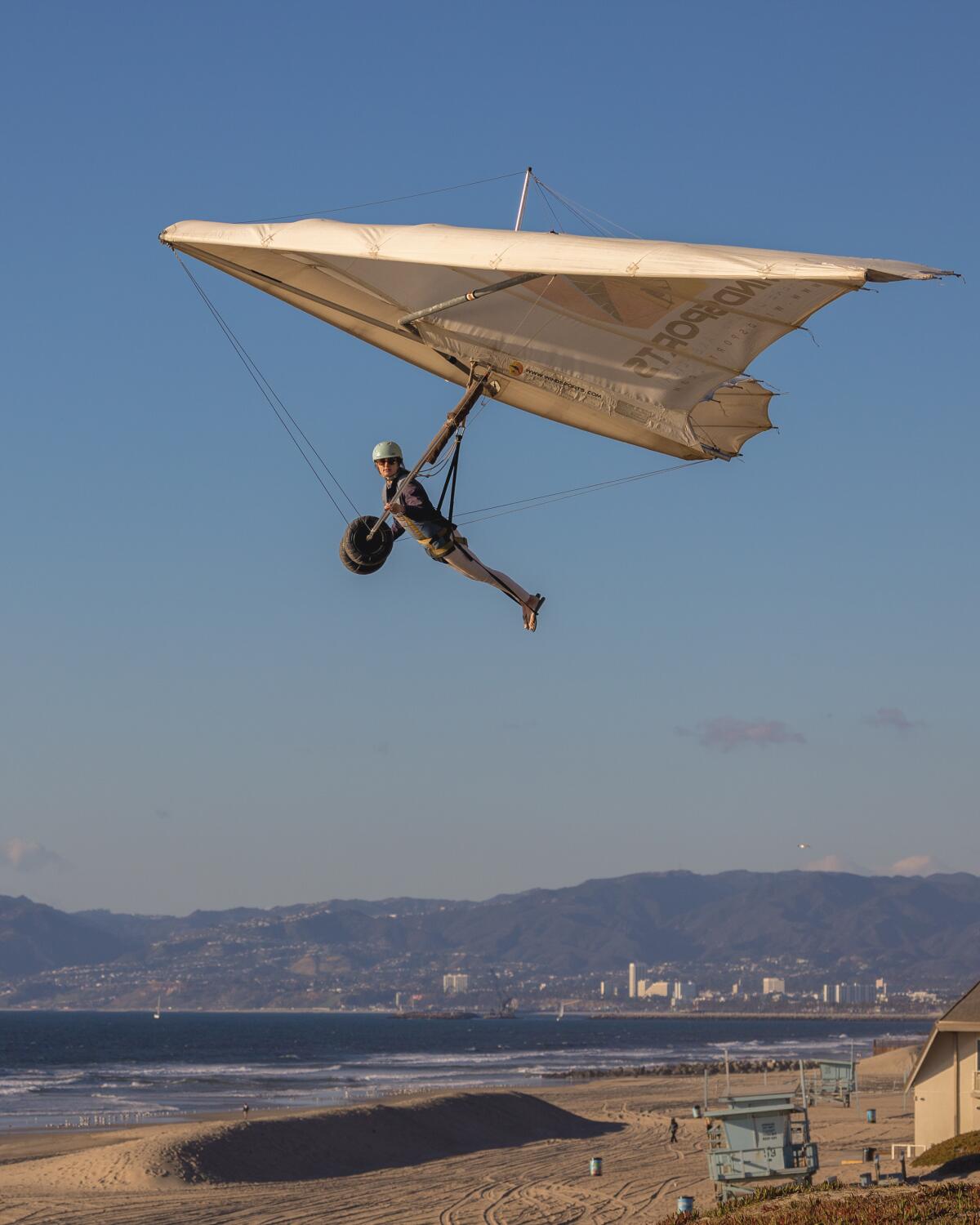 A hang glider above a beach.