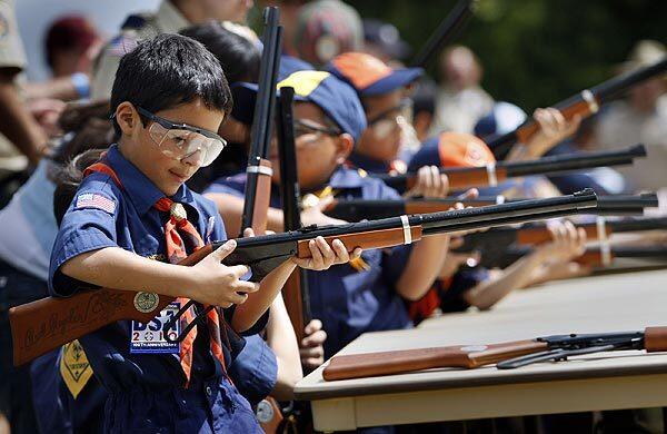 Ivan Ruiz, 7, a Tiger Cub Scout, cocks his BB gun as nearly 4,000 Los Angeles County Boy, Cub and Adventure Scouts and their adult leaders celebrate a three-day Cen-Ten-O-Ree at Whittier Narrows Recreation Area marking the 100th anniversary of the founding of the Boy Scouts of America.