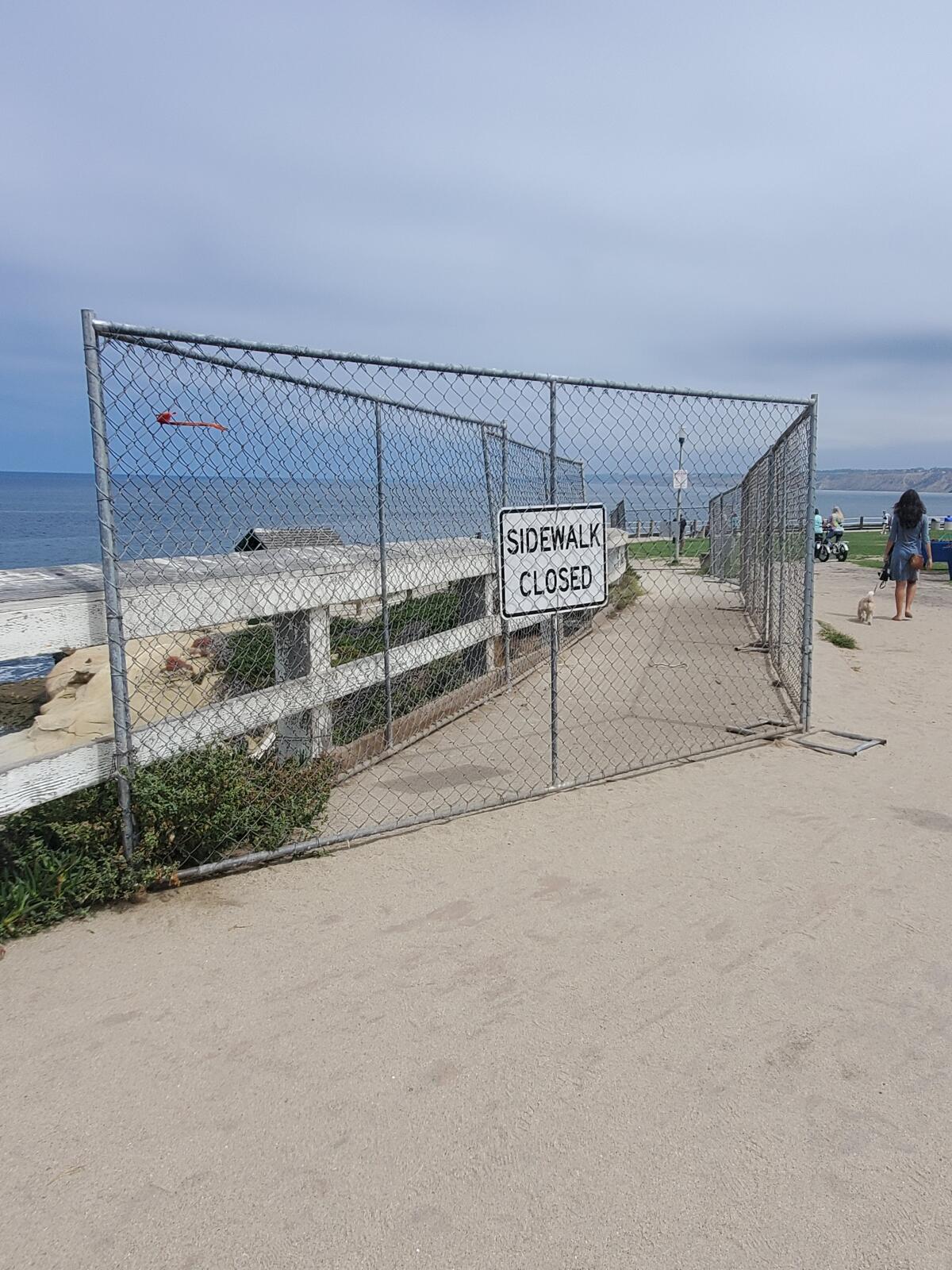 This fencing in Scripps Park will remain to keep people away from an eroding bluff.