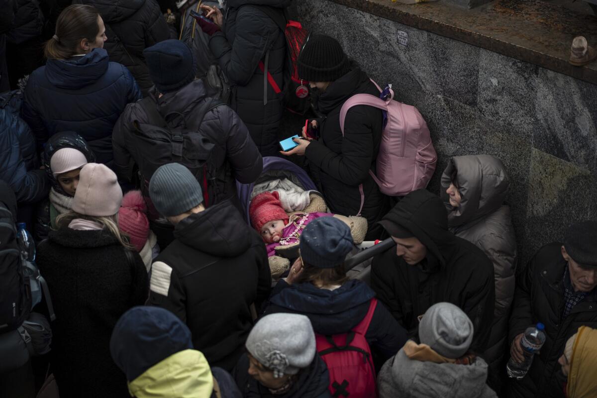 Passengers wait for a train to Poland, inside Lviv railway station