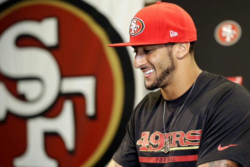 Quarterback Colin Kaepernick addresses the media last week after signing a six-year contract extension with the San Francisco 49ers.