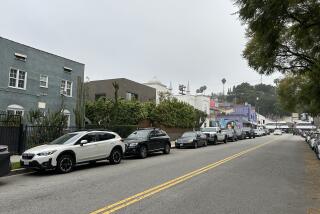 Buildings with diverse architecture on car-lined L.A. street