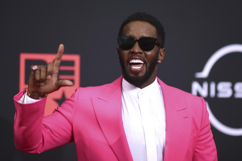 Sean "Diddy" Combs in a hot pink suit wearing sunglasses at the BET Awards