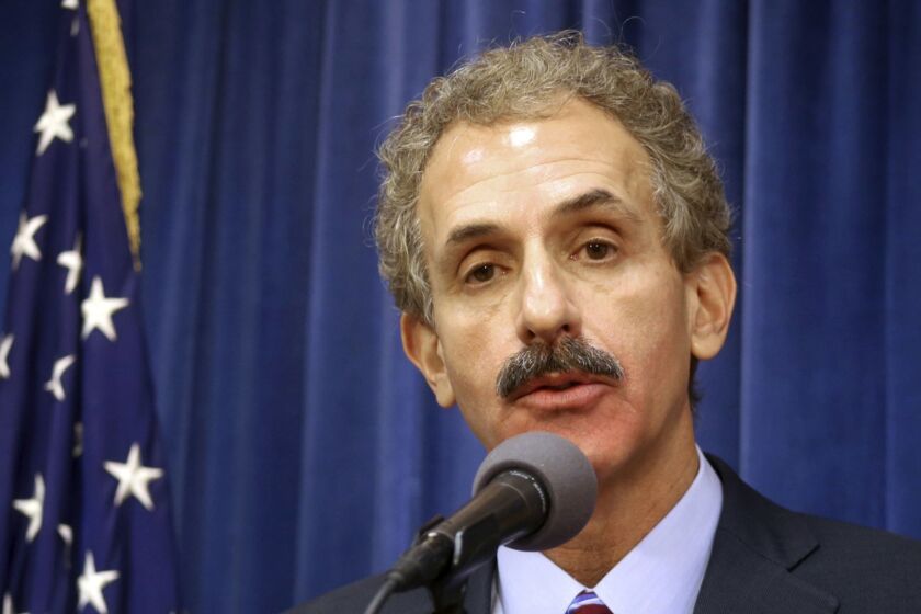 FILE - In this Aug. 31, 2017 file photo, Los Angeles City Attorney Mike Feuer speaks during a news conference in Los Angeles. The city of Los Angeles is suing an unlicensed marijuana dispensary, alleging the shop sold cannabis sprayed with a dangerous pesticide. City Attorney Mike Feuer says Wednesday, April 17, 2019 that pot sold at Kush Club 20 contained a fungicide frequently used on golf turf that the federal government classifies as a toxic chemical. The suit seeks a civil penalty of $20,000 for each day that illegal activity occurred at the property in South LA. (AP Photo/Mike Balsamo, File)