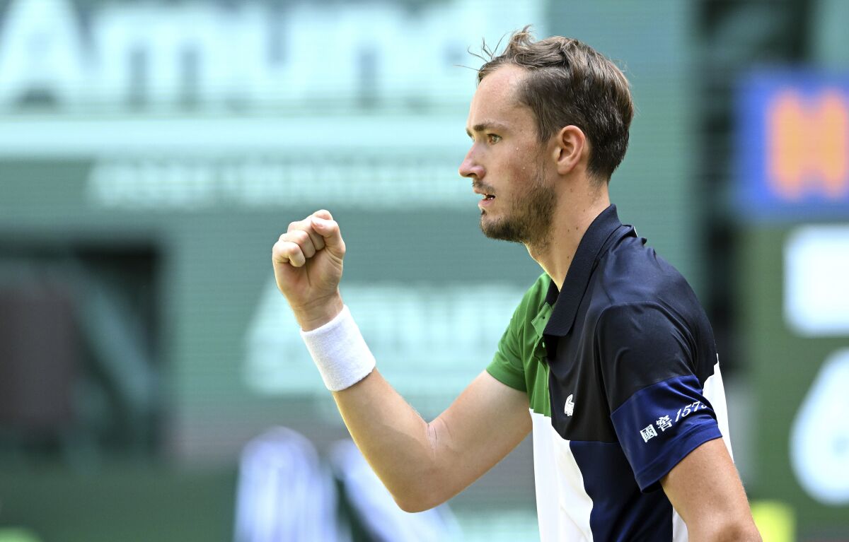 Russia's Daniil Medvedev celebrates winning a point against Germany's Oscar Otte during the ATP Tour men's singles semifinal match in Halle, Germany, Saturday June 18, 2022. (David Inderlied/dpa via AP)