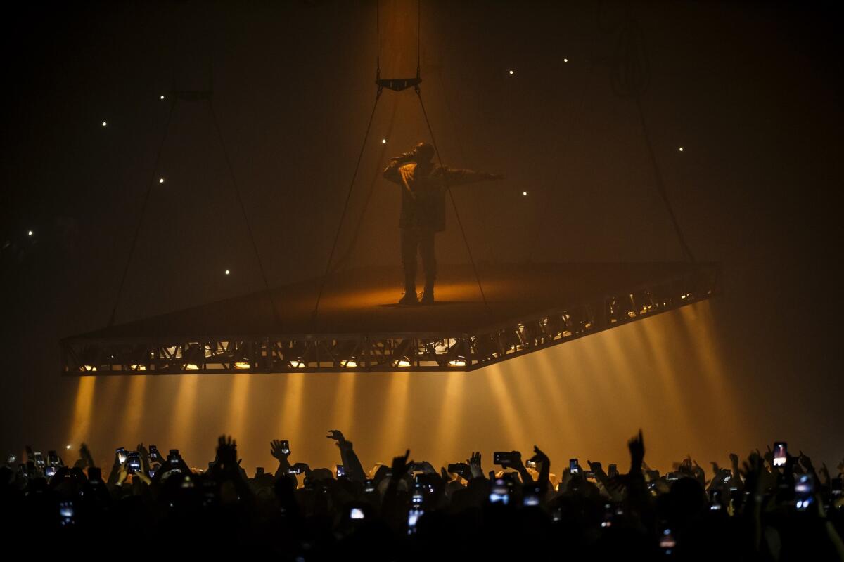 Kanye West performs on a floating stageat the Forum in Inglewood on Oct. 25. West ended his Thursday performance at the Forum mid-set after complaining of throat problems.