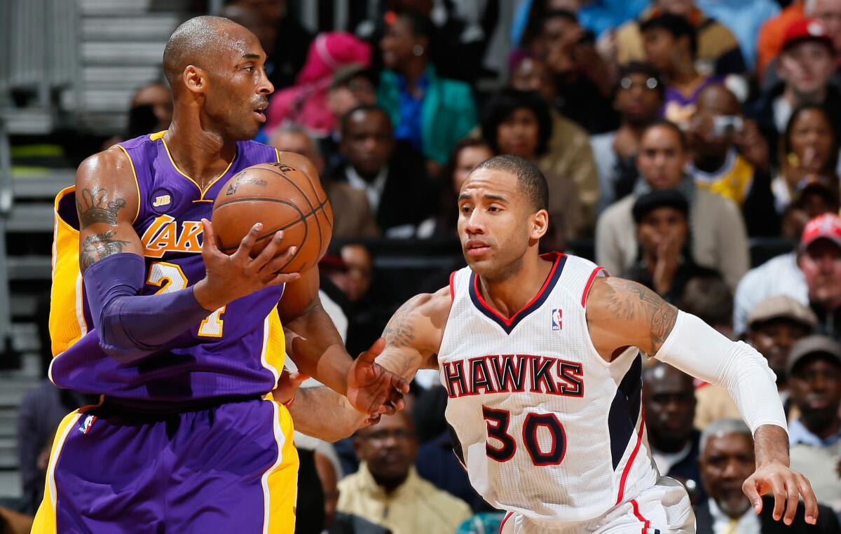 Dahntay Jones defends against the Lakers' Kobe Bryant as a member of the Atlanta Hawks on March 13, 2013.