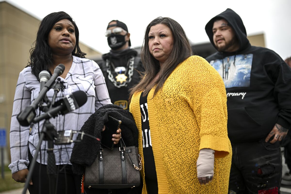 Katie Wright, center, stands beside activist Toshira Garraway and her son, Damik Bryant, during a news conference Thursday, May 5, 2022 outside the Brooklyn Center Police Station in Brooklyn Center, Minn. Katie Wright, the mother of Daunte Wright, said she was injured while she was briefly detained by one of the same department’s officers after she stopped to record an arrest of a person during a traffic stop. (Aaron Lavinsky /Star Tribune via AP)