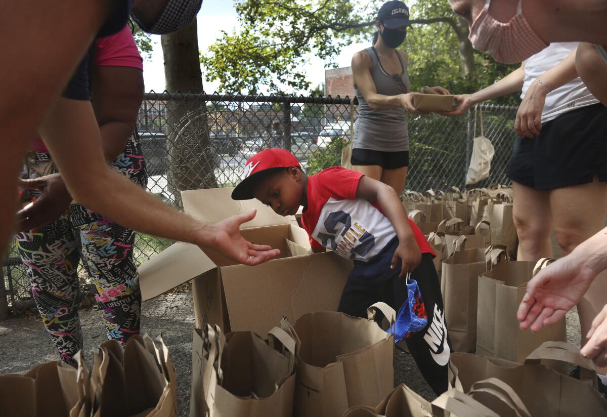 Hunter Stewart, 5, helps pack and deliver food 
