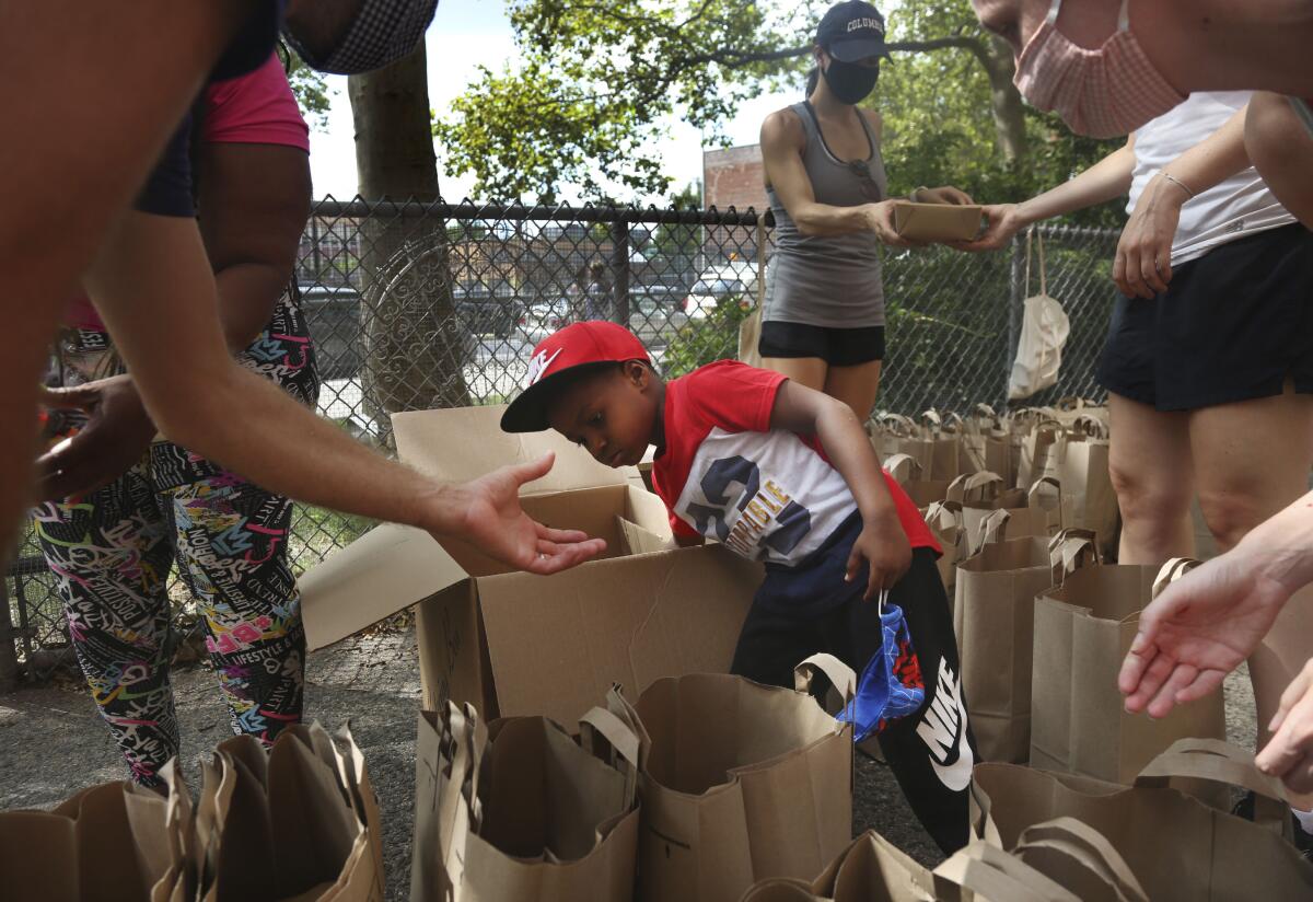 Hunter Stewart, 5, helps pack and deliver food