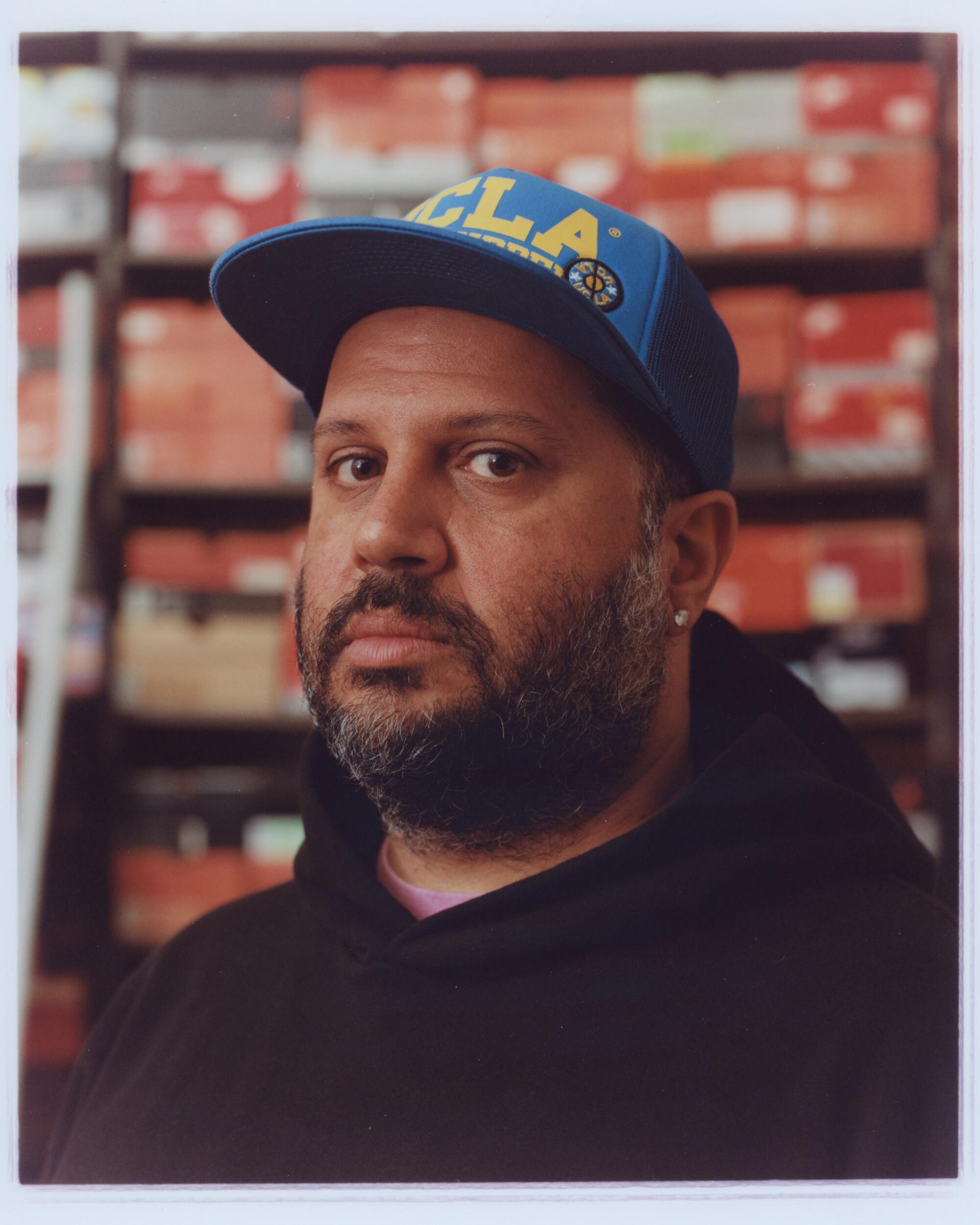 A bearded man in a UCLA baseball cap.