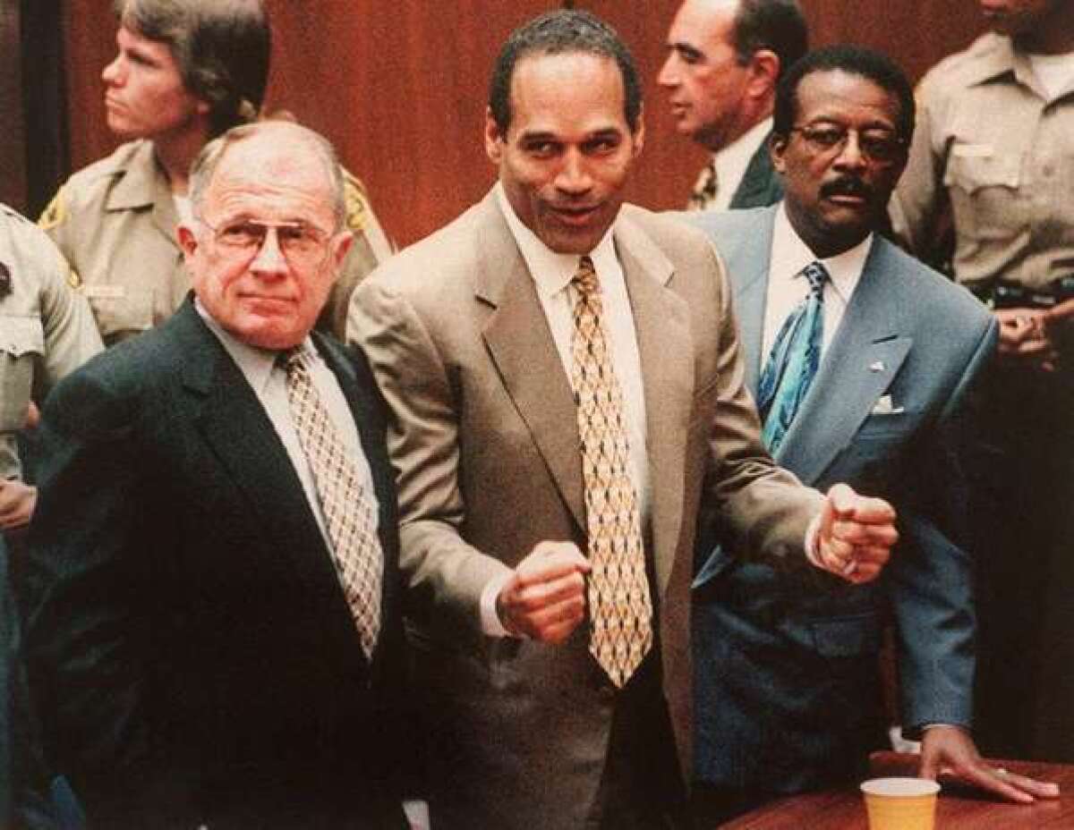 O.J. Simpson, flanked by his attorneys, reacts as he hears the not-guilty verdict in his 1995 murder trial. Some L.A. Times letter writers have made comparisons between Simpson's trial and the acquittal of George Zimmerman.