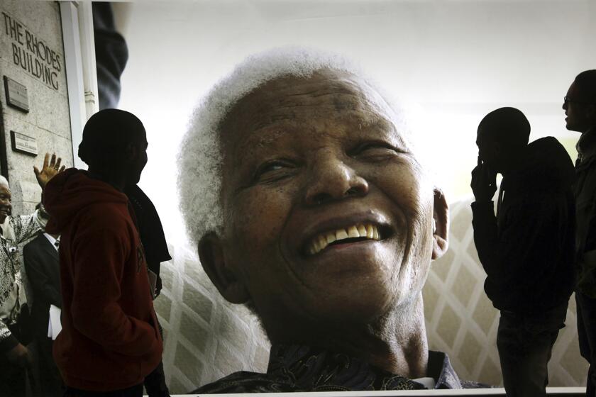 File — A photo of former South African President Nelson Mandela on display at the Nelson Mandela Legacy Exhibition in Cape Town, South Africa, on June 27, 2013. Today the ruling African National Congress (ANC) faces growing dissatisfaction from many who feel it has failed to live up to its promises. (AP Photo, File)