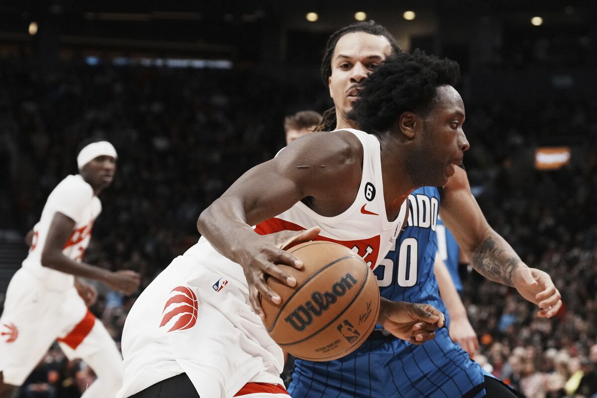 Toronto Raptors forward O.G. Anunoby drives past Orlando Magic's Cole Anthony during the first half of an NBA basketball game, Saturday, Dec. 3, 2022 in Toronto. (Chris Young/The Canadian Press via AP)
