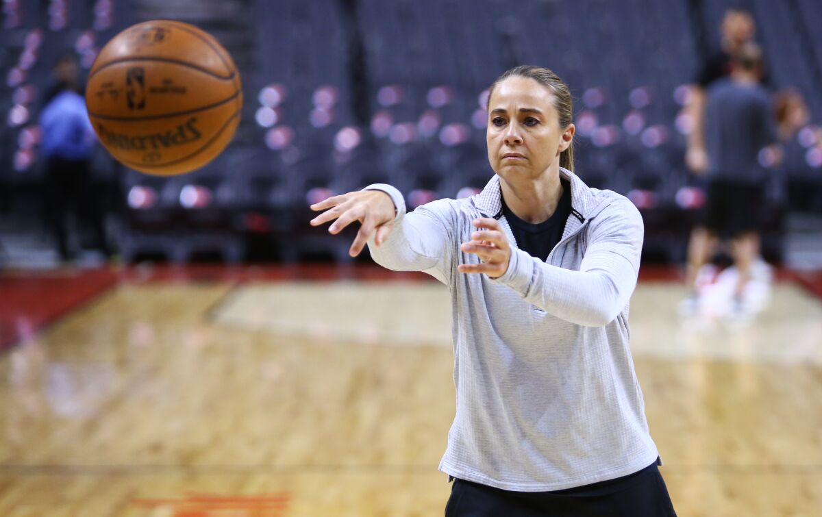 Spurs assistant coach Becky Hammon throws a pass during warmups.