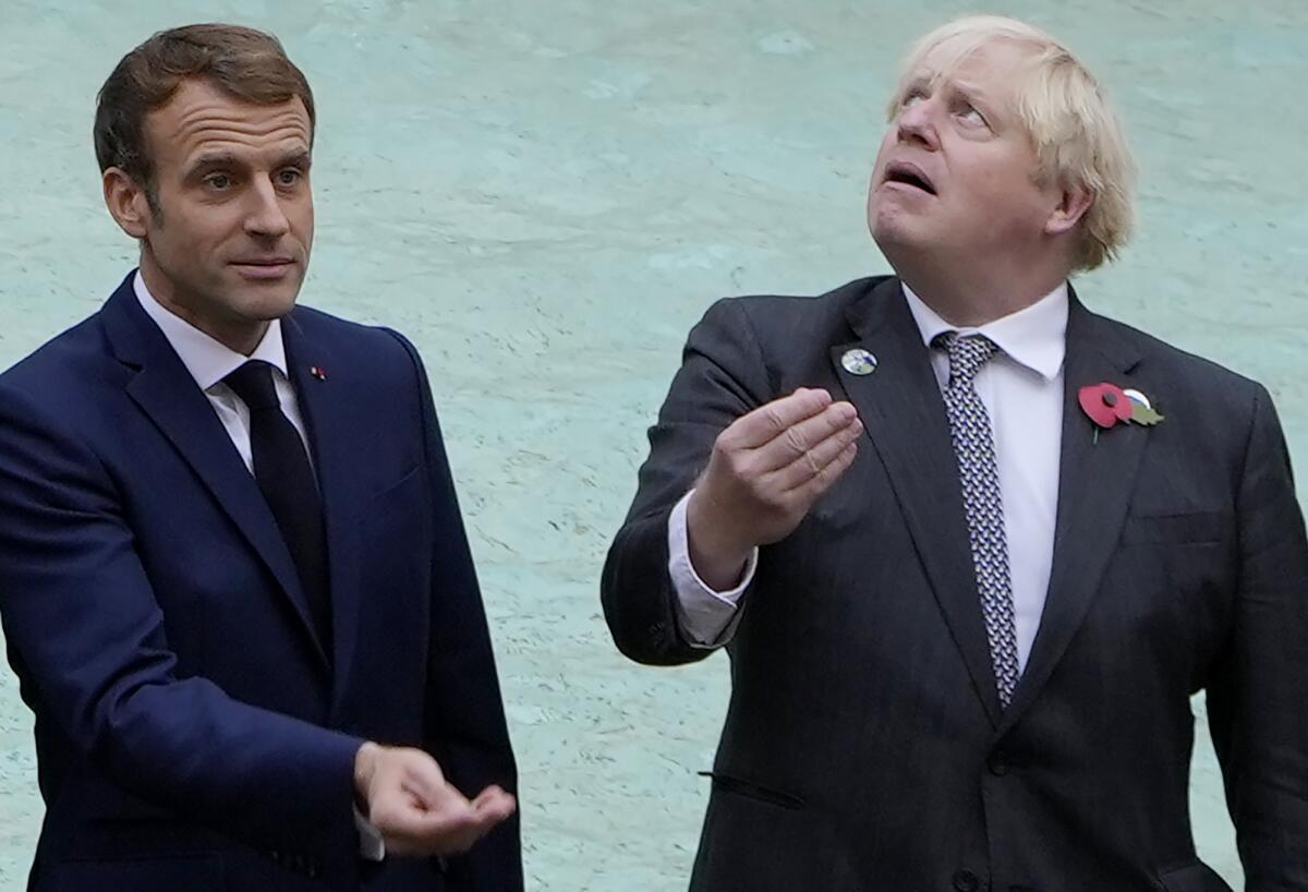 French President Emmanuel Macron, left, and British Prime Minister Boris Johnson