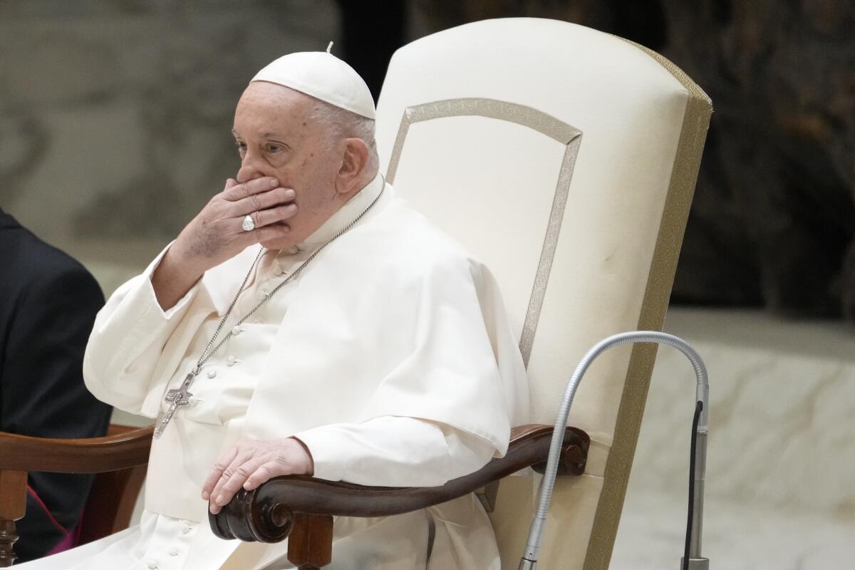 Pope Francis covering his mouth with his hand