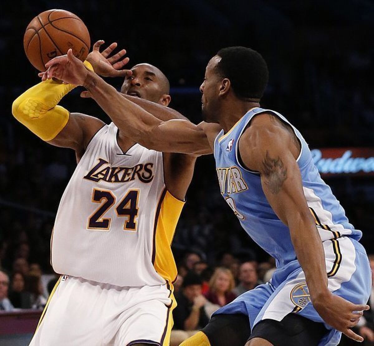 Nuggets' Andre Iguodala knocks the ball away from Lakers guard Kobe Bryant in the first half of a game last month.