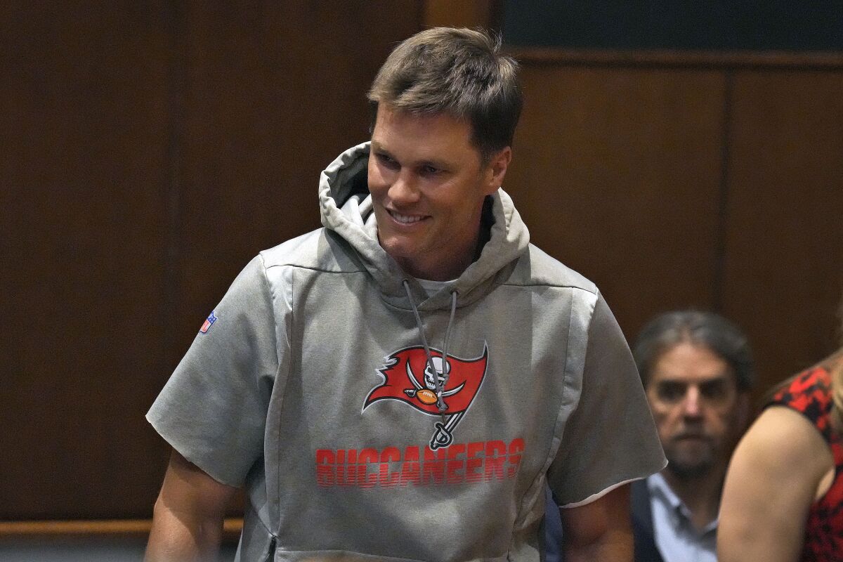 Tampa Bay Buccaneers quarterback Tom Brady smiles as he arrives for a news conference in March.