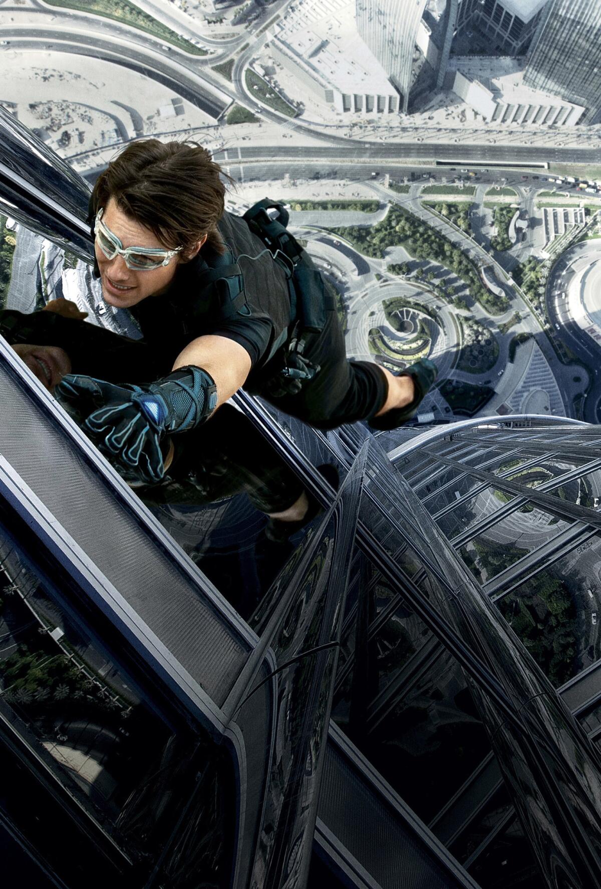Tom Cruise climbs a building in a scene from the film "Mission: Impossible â Ghost Protocol."